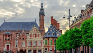 A picture of classic buildings on a canal bank in the city of Haarlem, which reflects a part of the beauty Netherlands
