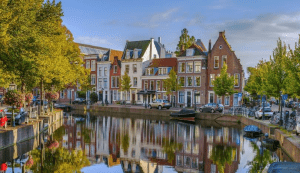 A picture of a canal in the city of Leiden, where traditional Dutch houses are lined up