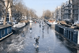 An artistic picture of historic windmills on the water, showing a side of the charm Netherlands. 